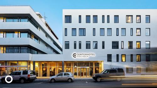 cars parked in front of a building at Midgardur by Center Hotels in Reykjavík