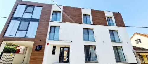 an apartment building with white and brown at Hotel B4 in Oradea