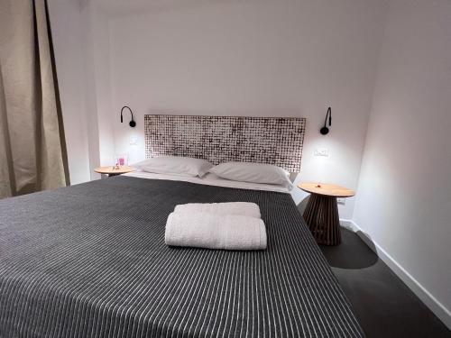 a bedroom with a large bed with two tables at Villa Chiara Taormina in Taormina