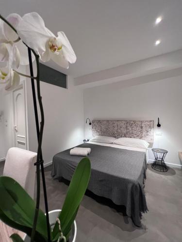 a bedroom with a bed and a white flower at Villa Chiara Taormina in Taormina