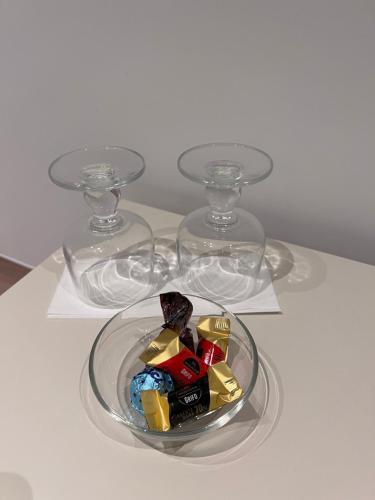 a bowl of candy on a table with two glasses at Villa Chiara Taormina in Taormina