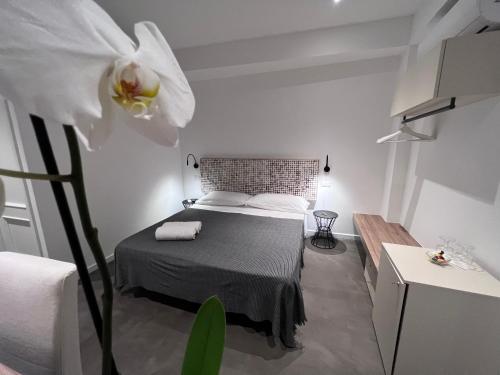 a bedroom with a bed and a white flower at Villa Chiara Taormina in Taormina