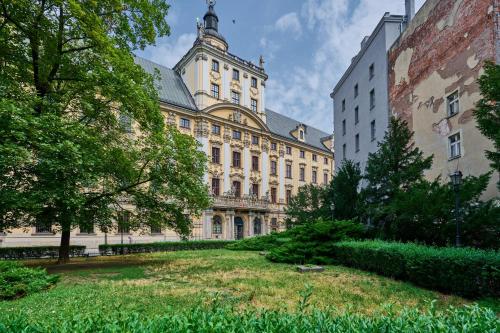 a large building with a yard in front of it at Heart of Wroclaw Uniwersytecka by Renters in Wrocław