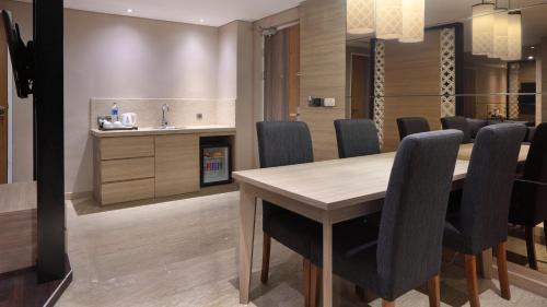 a dining room with a table and chairs at Holiday Inn Bandung Pasteur by IHG in Bandung