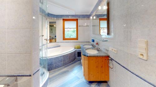 a bathroom with a tub and a sink at Ferienhaus Monz in Pfunds