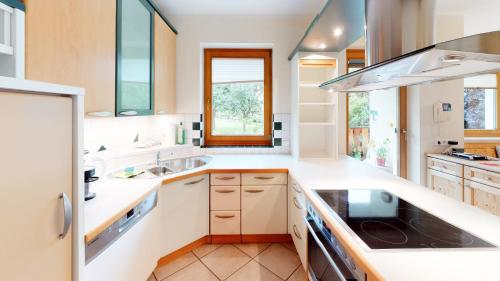 a kitchen with white counters and a sink at Ferienhaus Monz in Pfunds