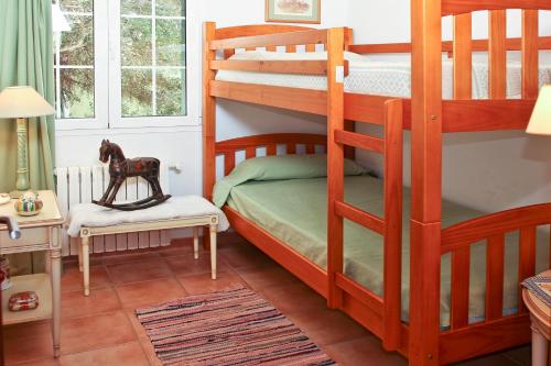 a bedroom with two bunk beds and a chair at Las Tórtolas in Alaior