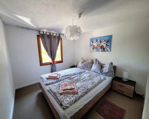 a bedroom with a bed with towels on it at L'ANGOLO DEI SAPORI in Rueun