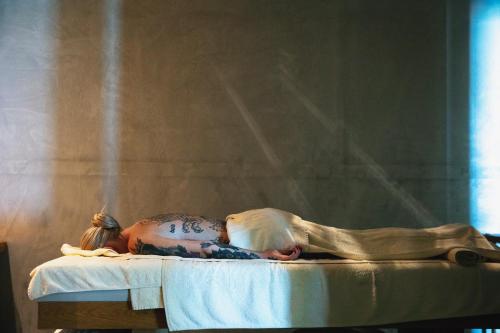 a statue of a child laying on a bed at La Mer Resort Spa Crete in Georgioupolis
