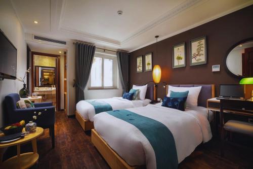 ハノイにあるHotel Emerald Waters Classyのホテルルーム ベッド2台&椅子付