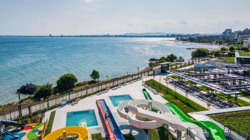 a view of a swimming pool and the water at Voya Beach Resort - Ultra All Inclusive in Sveti Vlas