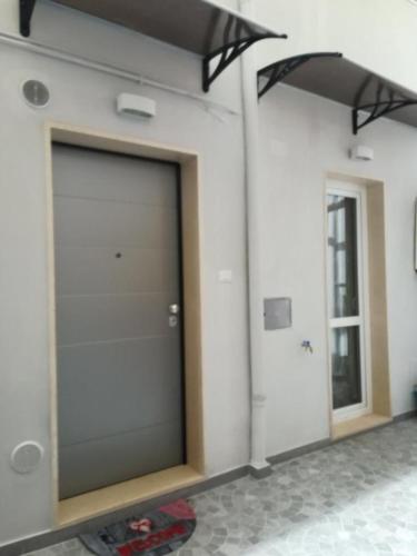 a garage door on a building with a window at Berenice Suite in Taranto