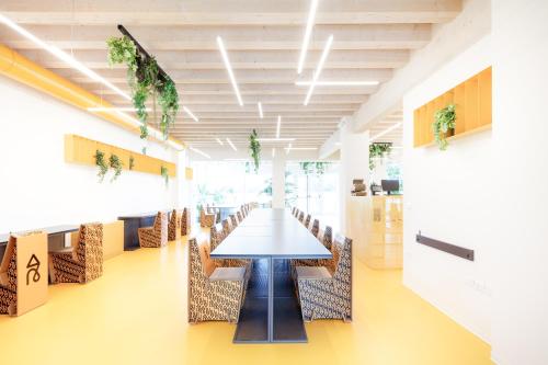 a conference room with a long table and chairs at Nomad Hostel in Treviso