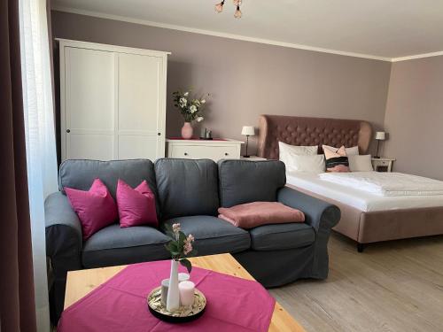 ein Wohnzimmer mit einer Couch und einem Bett in der Unterkunft City-Appartement 12.3. in Zwickau