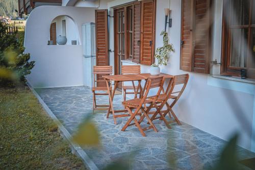 a wooden table and chairs on a patio at Majestic Apartment by Majestic Resorts Dolomites in Riscone