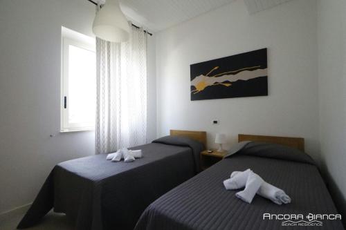 Postel nebo postele na pokoji v ubytování Ancora Bianca Beach Residence