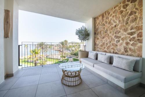 a living room with a couch and a balcony at Hotel & Spa Blau Parc in San Antonio