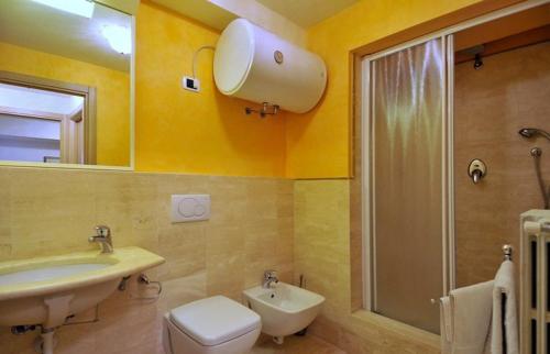 a bathroom with a sink and a toilet and a shower at Casa Paolina in Lucca