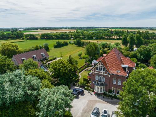 an aerial view of a large house with a parking lot at Villa Magnolia in Oostkapelle