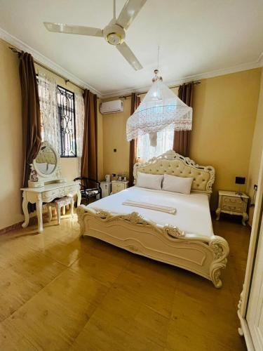 a bedroom with a large white bed in a room at Boshowa Villas in Nungwi