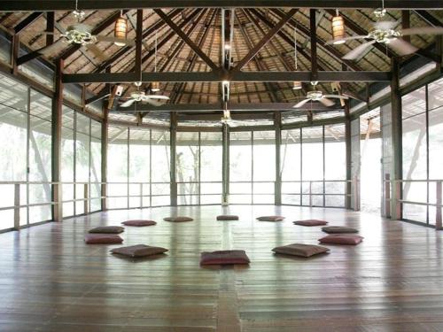a large room with mats on the floor of a building at Bambu Huts in Baan Tai