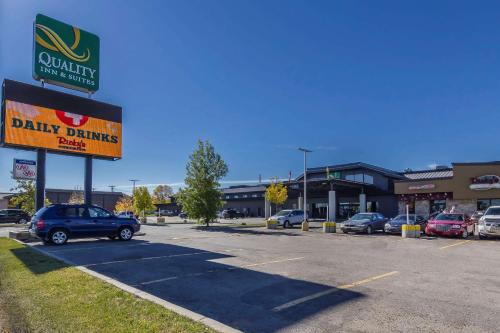 a dealership with a car parked in a parking lot at Quality Inn & Suites in Saskatoon