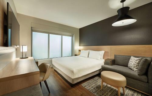 pokój hotelowy z łóżkiem i kanapą w obiekcie Hyatt Place Toronto-Brampton w mieście Brampton