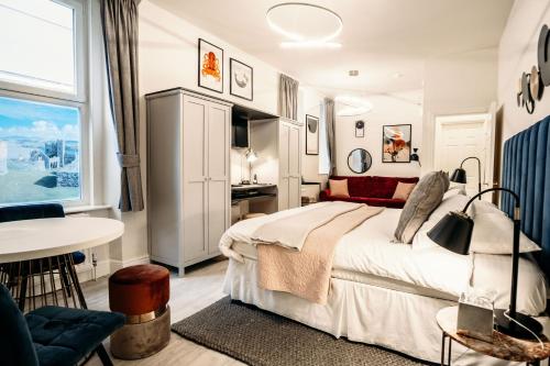 a hotel room with a bed and a table at The Town House in Douglas