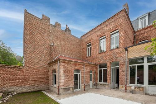 an exterior view of a brick building at Maison Mimerel Colodge in Roubaix