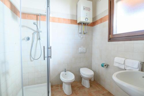 a bathroom with a shower and a toilet and a sink at Residenza Principina in Principina Terra