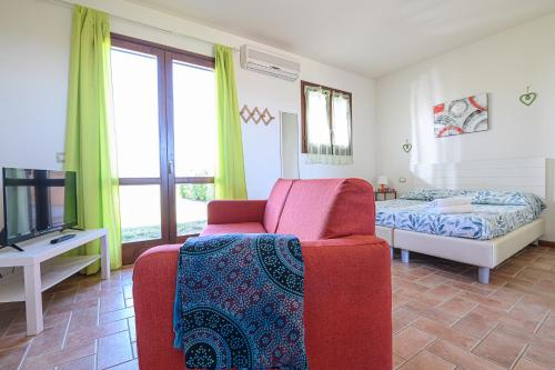 a living room with a couch and a bed at Residenza Principina in Principina Terra