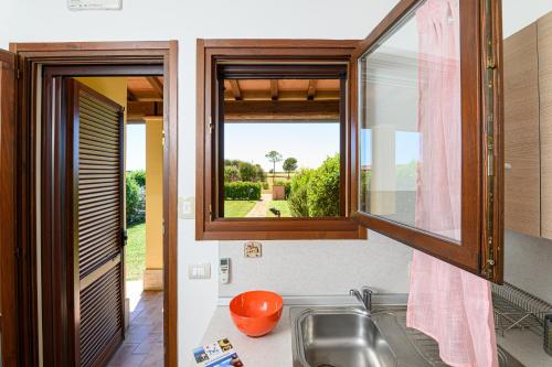 a kitchen with a sink and a window at Residenza Principina in Principina Terra