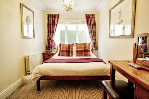 a bedroom with a bed and a window at The Town House in Douglas