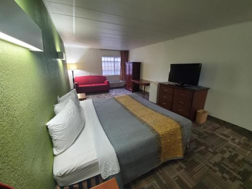 a hotel room with a bed and a television at Royal Inn Hotel in Indianapolis