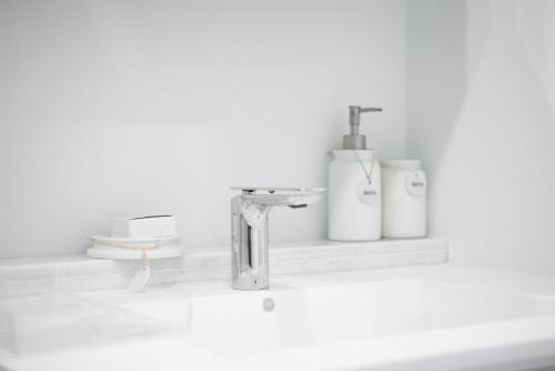 a bathroom counter with a sink and a faucet at Luxury 1 bed apartment near Seven Mile Beach at The Grove - Villa Zen in Upper Land
