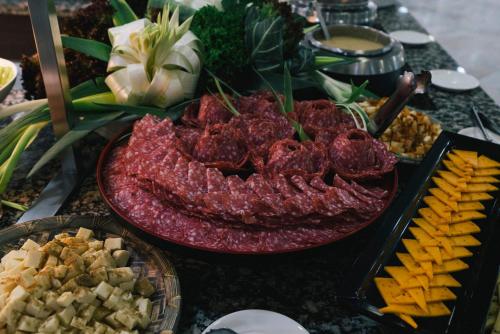 a table topped with meats and cheese and other foods at AluaSun Costa Park in Torremolinos