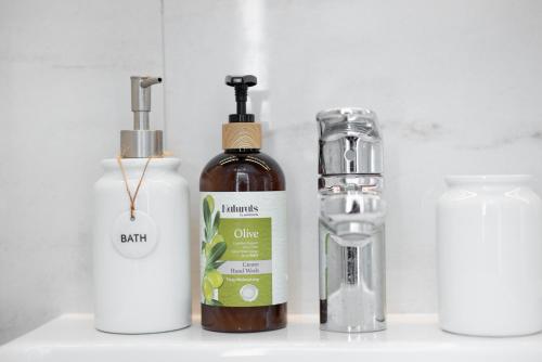 a counter with three bottles and a blender at STUDIO apartment near Seven Mile Beach at The Grove in Upper Land