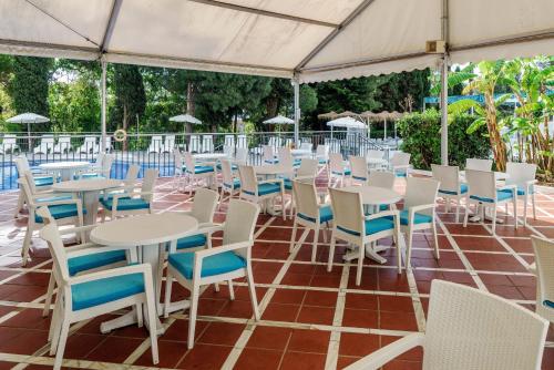 a group of tables and chairs under a tent at AluaSun Costa Park in Torremolinos