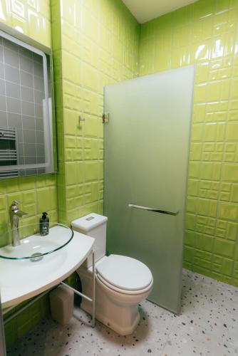 a bathroom with a toilet and a sink and a mirror at Ati Ambavi Botique Hotel Gudauri in Gudauri