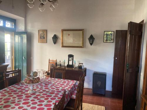 a dining room with a table with a red and white table cloth at Quinta de SantAna da Várzea in Abrantes