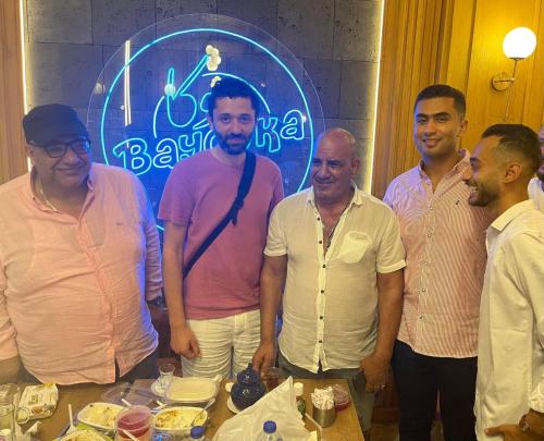 a group of men standing in front of a table at Chalet at Grand Hills Village - ONLY For Family in El Hamam