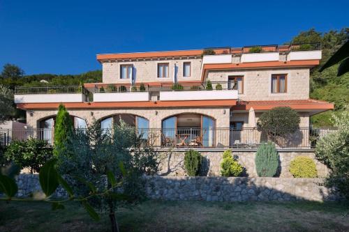 a large house with a fence in front of it at Villa Gradina in Budva