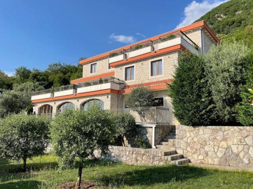 a house on a hill with trees in front of it at Villa Gradina in Budva