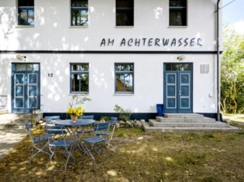 an apartment house with a table and chairs in front of it at 3-Raum Familienapartment bis 4 Pers 53 in Rankwitz
