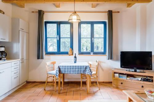 uma cozinha com mesa e cadeiras e uma televisão em 2-Raum Apartment bis 4 Pers 32 em Rankwitz