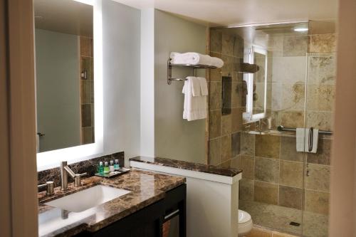 a bathroom with a sink and a shower at Wyndham Vacation Resorts Royal Garden at Waikiki in Honolulu