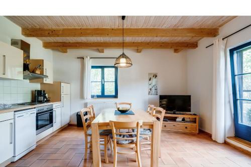 a kitchen and dining room with a table and chairs at 4-Raum Apartment bis 8 Pers 43 in Rankwitz