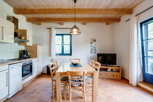 a kitchen with a dining room table and chairs at 4-Raum Apartment bis 8 Pers 41 in Rankwitz