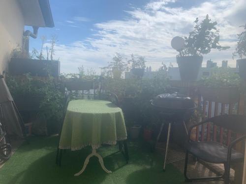 une table et des chaises dans un jardin avec des plantes dans l'établissement Belle chambre privée dans un appartement à Nogent sur Marne, à Nogent-sur-Marne