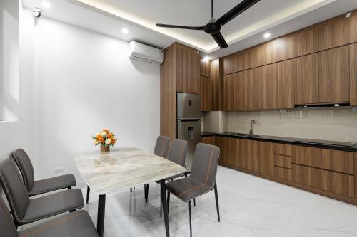 a kitchen and dining room with a table and chairs at Lakeside House 2 in Hanoi